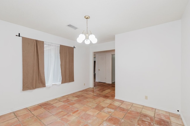 unfurnished room with an inviting chandelier