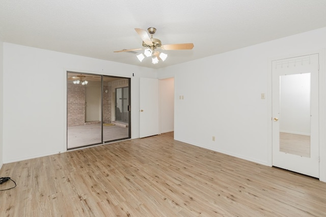 empty room featuring ceiling fan, a textured ceiling, and light wood-type flooring