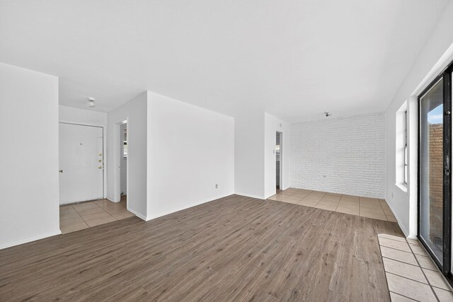 204 Acklen, Midland, TX 79703 - empty room with wood finished floors and brick wall