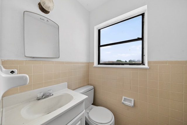 204 Acklen, Midland, TX 79703 - half bathroom featuring tile walls, vanity, and wainscoting