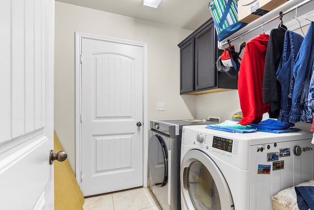 washroom featuring light tile patterned floors, cabinets, and independent washer and dryer