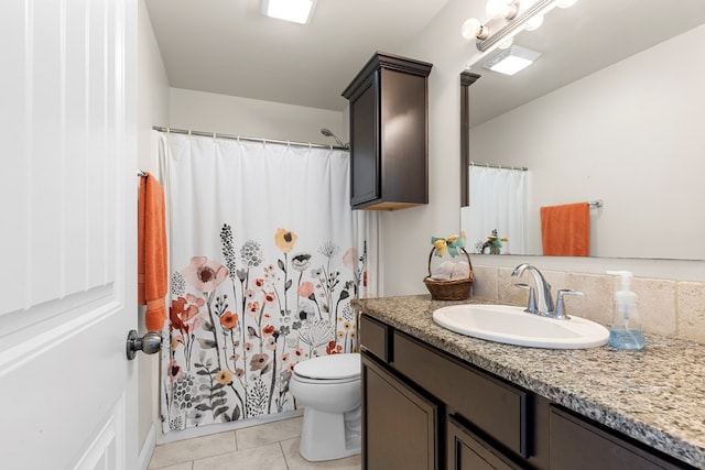 bathroom featuring tile patterned flooring, vanity, and toilet