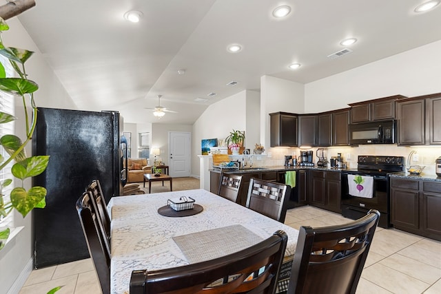 kitchen featuring decorative backsplash, vaulted ceiling, ceiling fan, black appliances, and light tile patterned floors