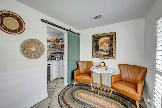3513 Stanolind Ave, Midland, TX 79707 - living area featuring wine cooler, a barn door, and light tile patterned floors