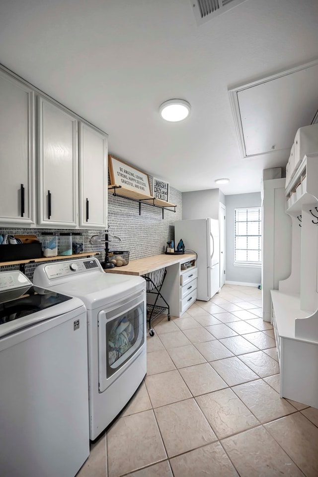 3513 Stanolind Ave, Midland, TX 79707 - laundry area with washing machine and dryer, attic access, and light tile patterned floors