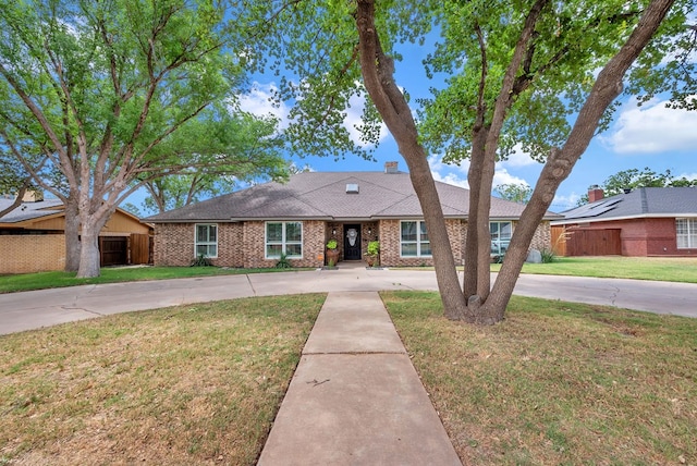 3513 Stanolind Ave, Midland, TX 79707 - view of front of home with curved driveway, brick siding, and a shingled roof