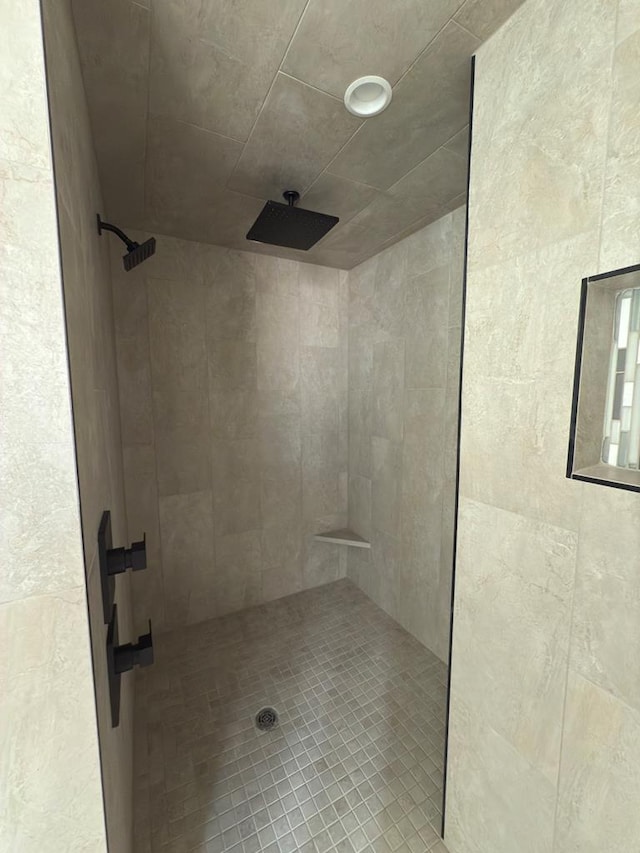 bathroom with tiled shower