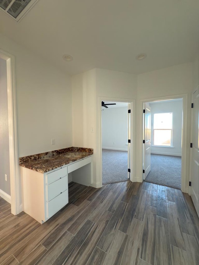 corridor featuring dark hardwood / wood-style floors