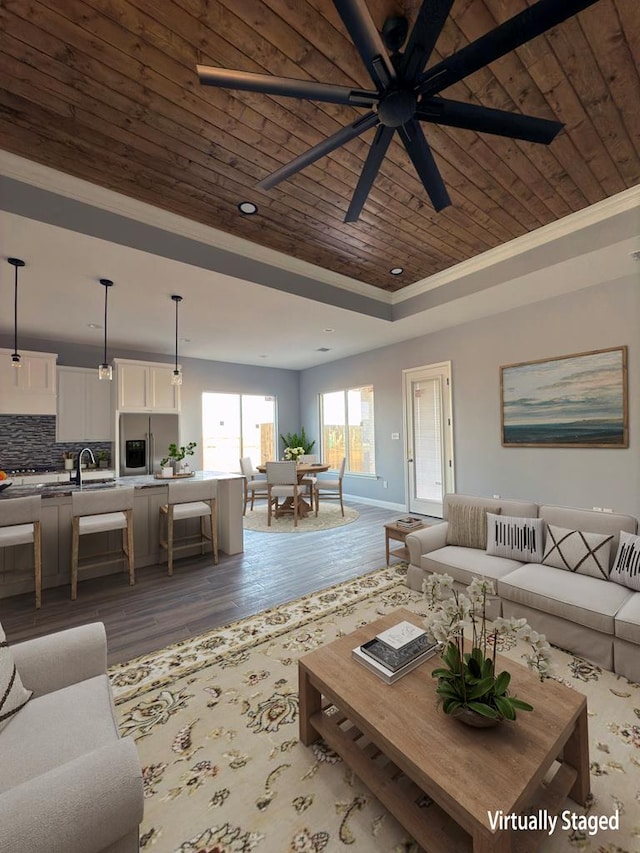 living room featuring sink, wood ceiling, a tray ceiling, ceiling fan, and light hardwood / wood-style floors