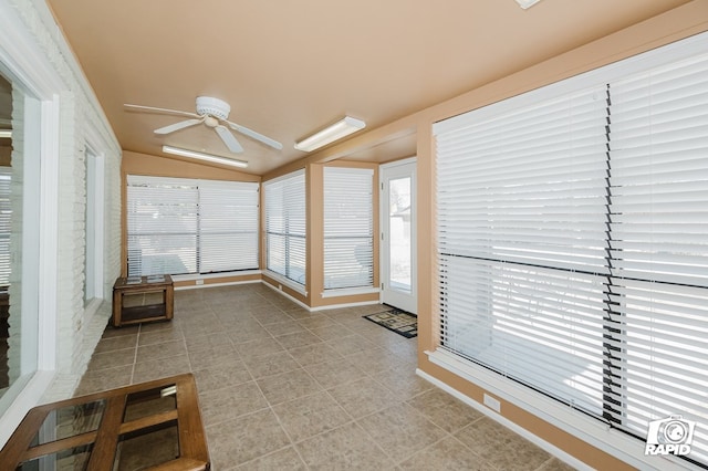 unfurnished sunroom with lofted ceiling and ceiling fan