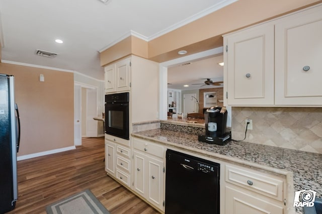 kitchen featuring black appliances, ornamental molding, visible vents, and light stone countertops