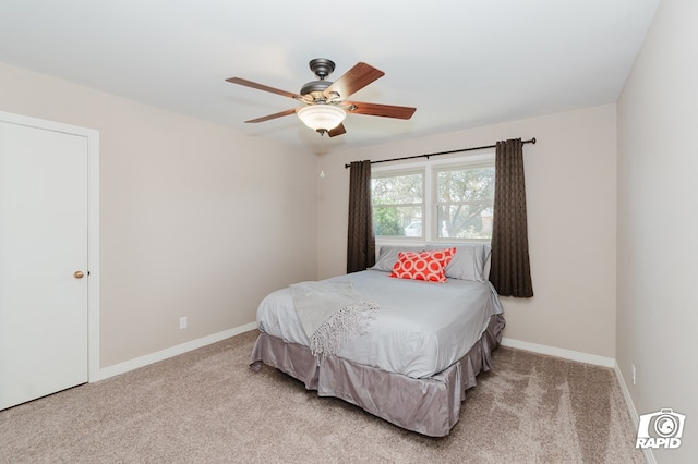 bedroom featuring light colored carpet, ceiling fan, and baseboards