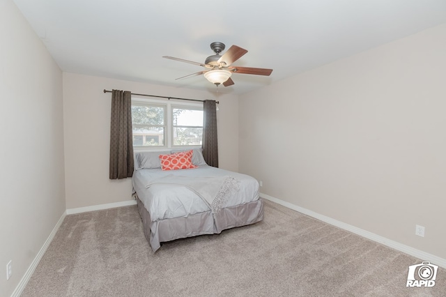 bedroom featuring light colored carpet, ceiling fan, and baseboards