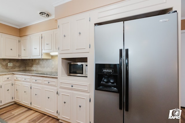 kitchen featuring stainless steel appliances, tasteful backsplash, visible vents, and white cabinets