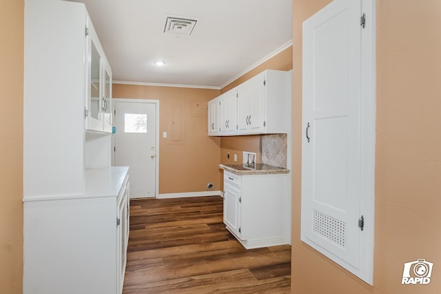 kitchen with visible vents, glass insert cabinets, and white cabinets