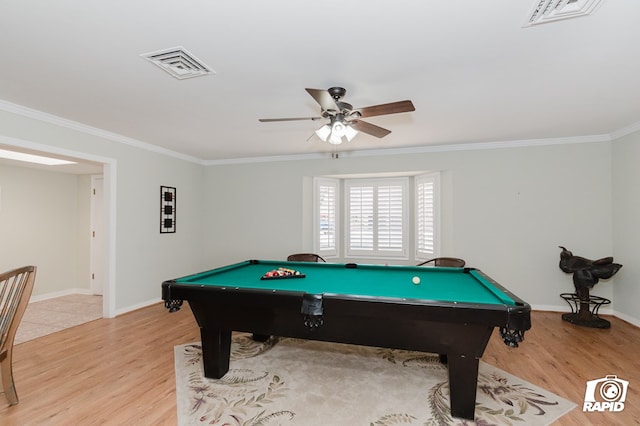 playroom with light wood finished floors, visible vents, and crown molding