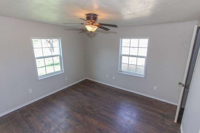 unfurnished room with a textured ceiling, dark hardwood / wood-style flooring, ceiling fan, and a healthy amount of sunlight