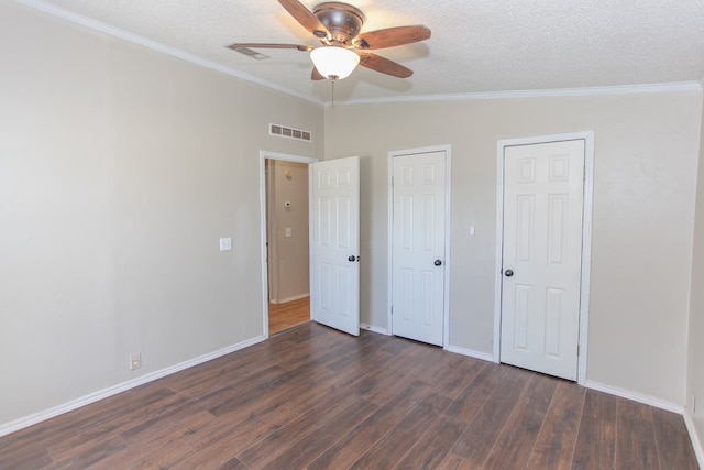 unfurnished bedroom featuring ceiling fan, crown molding, and dark hardwood / wood-style floors