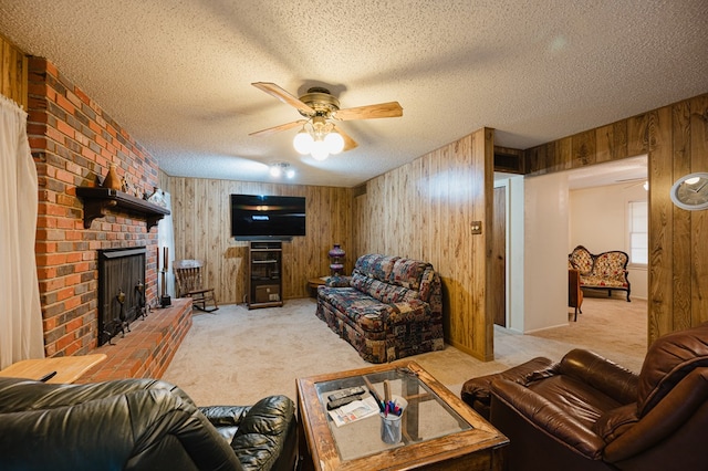 living room featuring a textured ceiling, light colored carpet, ceiling fan, and wooden walls