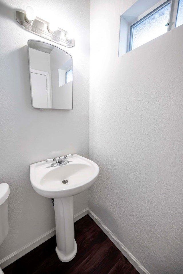 bathroom featuring hardwood / wood-style floors and toilet