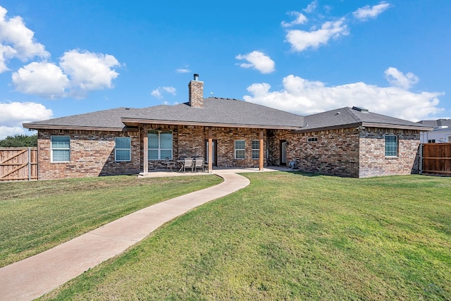 view of front of home with a patio area and a front lawn