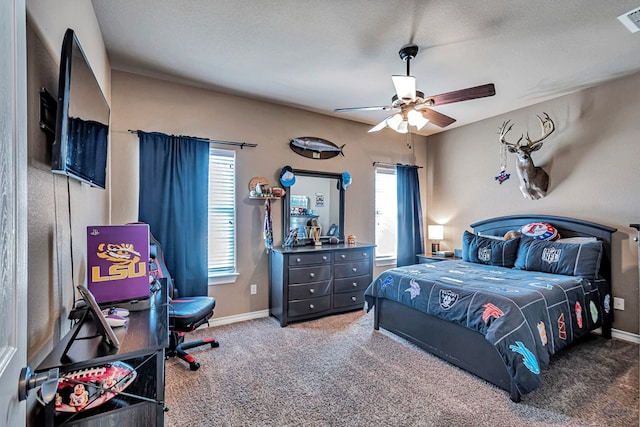 bedroom featuring carpet flooring, ceiling fan, and a textured ceiling