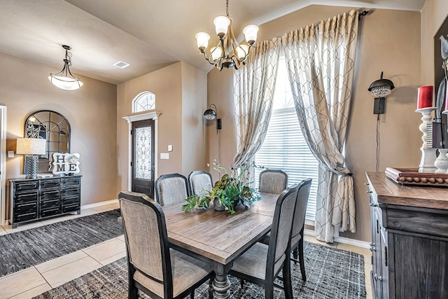 dining space featuring light tile patterned floors and an inviting chandelier