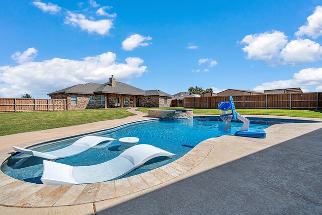 view of pool with a lawn and an in ground hot tub