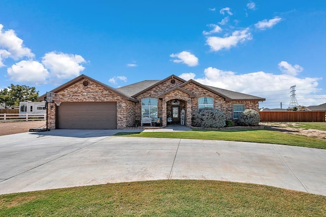 view of front of house with a front yard and a garage