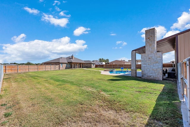 view of yard with a fenced in pool