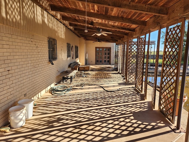 view of patio / terrace featuring a water view and ceiling fan