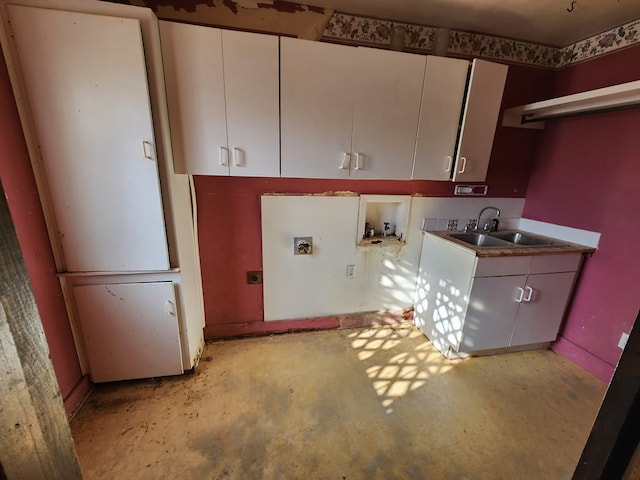 clothes washing area featuring washer hookup, electric dryer hookup, cabinets, and sink