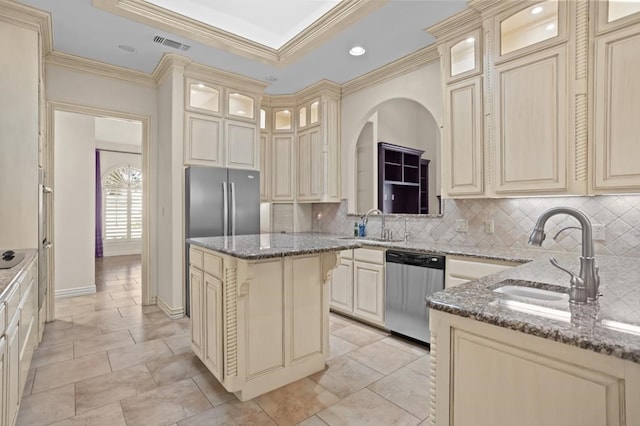 kitchen featuring dishwasher, cream cabinetry, and a sink