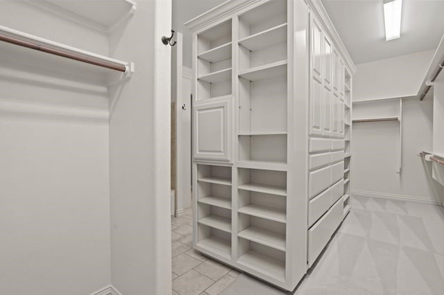 spacious closet featuring light tile patterned flooring