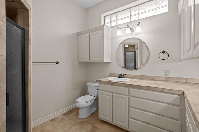 bathroom featuring a shower stall, baseboards, vanity, and toilet