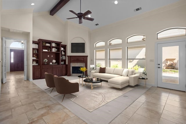 living room featuring a fireplace with raised hearth, high vaulted ceiling, visible vents, ornamental molding, and beam ceiling