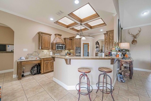 kitchen with a kitchen breakfast bar, light stone countertops, ornamental molding, appliances with stainless steel finishes, and kitchen peninsula