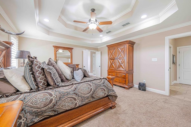 bedroom featuring ceiling fan, ornamental molding, light carpet, and a tray ceiling