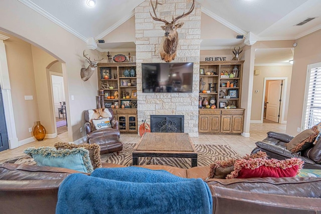 living room featuring a stone fireplace, ornamental molding, light tile patterned floors, and vaulted ceiling