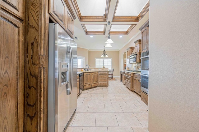 kitchen with stainless steel appliances, crown molding, sink, light tile patterned floors, and decorative light fixtures