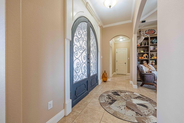 entryway with light tile patterned flooring, crown molding, and french doors