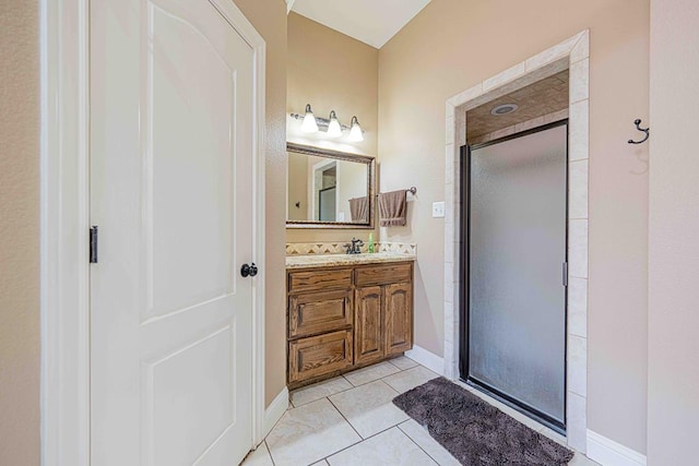 bathroom featuring tile patterned flooring, vanity, and a shower with door