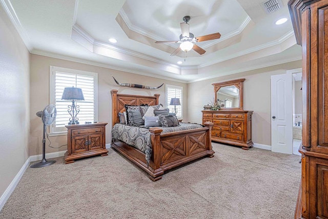 carpeted bedroom with a tray ceiling, ceiling fan, and crown molding