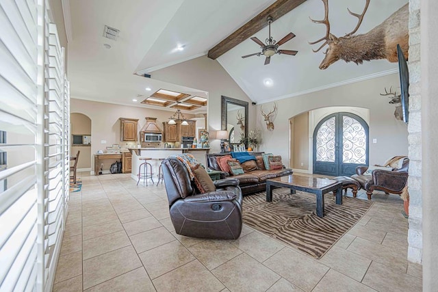 living room with ceiling fan, french doors, vaulted ceiling with beams, crown molding, and light tile patterned floors