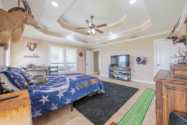 bedroom featuring a tray ceiling, crown molding, and ceiling fan