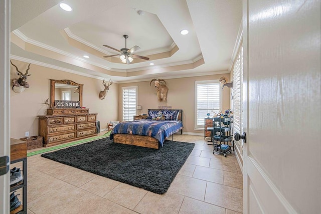 tiled bedroom featuring ceiling fan, crown molding, and a tray ceiling