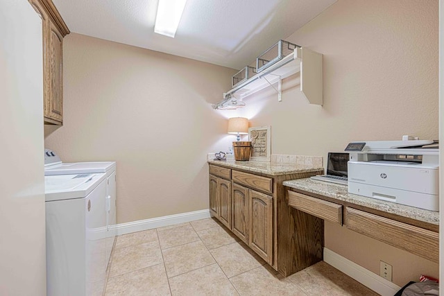 laundry room featuring washer and clothes dryer and light tile patterned floors