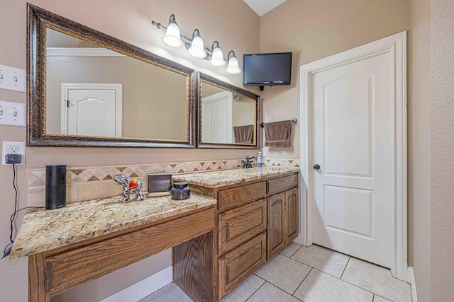 bathroom featuring tile patterned flooring, decorative backsplash, and vanity