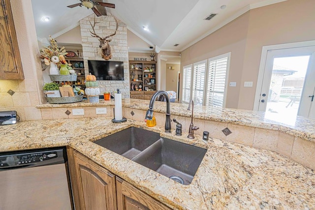 kitchen with a wealth of natural light, lofted ceiling with beams, sink, and stainless steel dishwasher