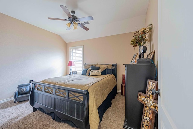 carpeted bedroom with ceiling fan and vaulted ceiling